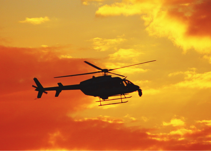 Helicopter flying at the sunset