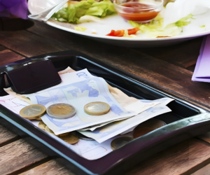 Local Costa Rican restaurant with cash left as a tip, illustrating tipping etiquette.